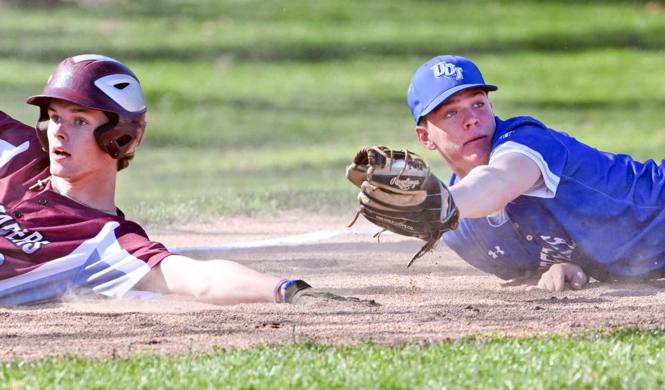 Josh Wiggin of Cape Tech slides safely into third past the tag of Tyler Kutil of Upper Cape Tech
(Credit: Ron Schloerb/Cape Cod Times)