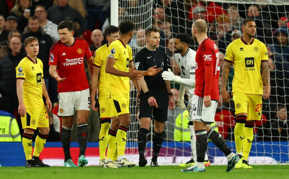 Soccer Football - Premier League - Manchester United v Sheffield United - Old Trafford, Manchester, Britain - April 24, 2024 Sheffield United players remonstrate with referee Michael Salisbury after a penalty is awarded