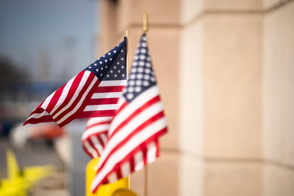 Feb 21, 2024; Columbus, Ohio, USA; American flags are tied to bollards near the entrance to the Early Voting entrance at the Franklin County Board of Elections.