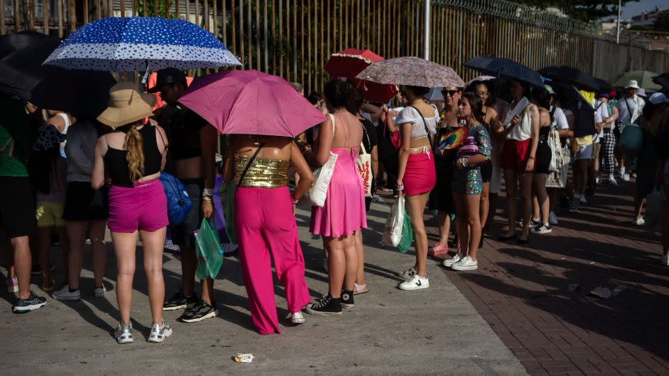 Fans of Taylor Swift queue outside the Nilton Santos Olympic Stadium before Swift's concert, "Taylor Swift: The Eras Tour", amid a heat wave in Rio de Janeiro on November 18. - Tercio Teixeira/AFP/Getty Images