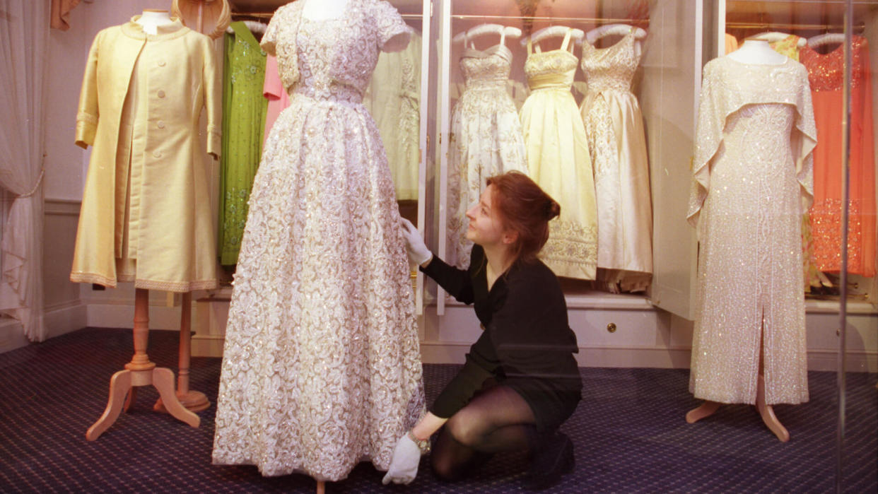 Curator Jenny Lister Arranges One Of Many Of The Queen Elizabeth II's Dresses On Display At A New Exhibition At Kensington Palace.