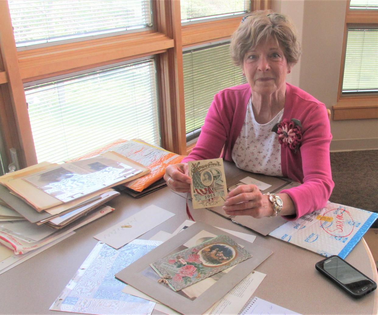 Polly Walgren displays a souvenir her grandmother Amelia Burkey gave to her graduates from the Class of 1911. Burkey taught for two years at South Bunker Hill School,  an old one-room schoolhouse on County Road 77 in Holmes County near Berlin.
