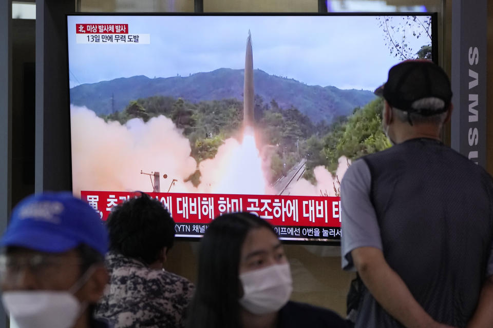 People watch a TV showing a file image of North Korea's missile launch during a news program at the Seoul Railway Station in Seoul, South Korea, Tuesday, Sept. 28, 2021. North Korea on Tuesday fired a suspected ballistic missile into the sea, Seoul and Tokyo officials said, the latest in a series of weapons tests by Pyongyang that raised questions about the sincerity of its recent offer for talks with South Korea. (AP Photo/Ahn Young-joon)