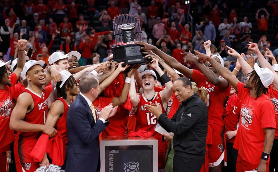 The N.C. State team raises the championship trophy after the Wolfpack’s 84-76 victory over UNC in the championship game of the 2024 ACC Men’s Basketball Tournament at Capital One Arena in Washington, D.C., Saturday, March 16, 2024. Ethan Hyman/ehyman@newsobserver.com