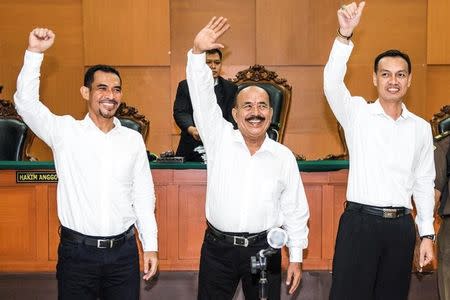 The leaders of Gafatar group (L-R) Mahful Muis Tumanurung, Ahmad Musadeq and Andry Cahya wave their hands during their trial at East Jakarta district court in Indonesia, March 7, 2017 in this photo taken by Antara Foto. Picture taken March 7, 2017. Antara Foto/M Agung Rajasa/ via REUTERS