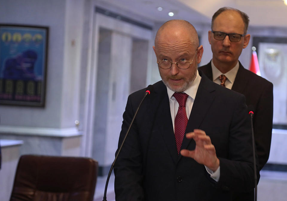 Rory Robertshaw, center, UNESCO Senior Project Officer in Iraq, addresses reporters during a press conference about recently recovered antiquities at the foreign ministry, in Baghdad, Iraq, Monday, July 29, 2019. The artifacts paraded Monday include archaeological and historical pieces recovered from Britain and Sweden, pottery fragments and shards with writing dating back to the ancient Sumerian civilization. The restoration of Iraq's cultural heritage is now gaining momentum and UNESCO is working closely with the Iraqi authorities. (AP Photo/Hadi Mizban)