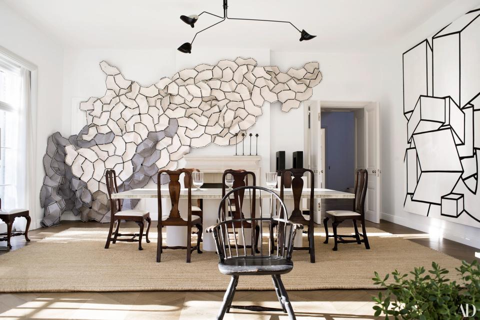 In the dining room, a felt wall sculpture by Ronan and Erwan Bouroullec makes a splash. Serge Mouille suspension light; Martin Szekely table; Queen Anne dining chairs; Windsor chair (foreground).