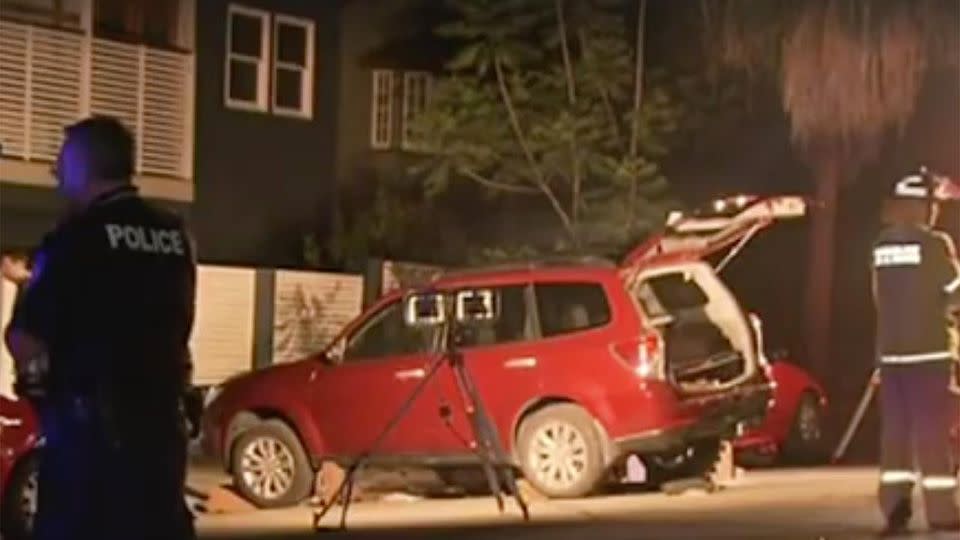 A teenage boy was trapped under the car after his father accidentally ran him and his mother over in their driveway. Photo: 7 News