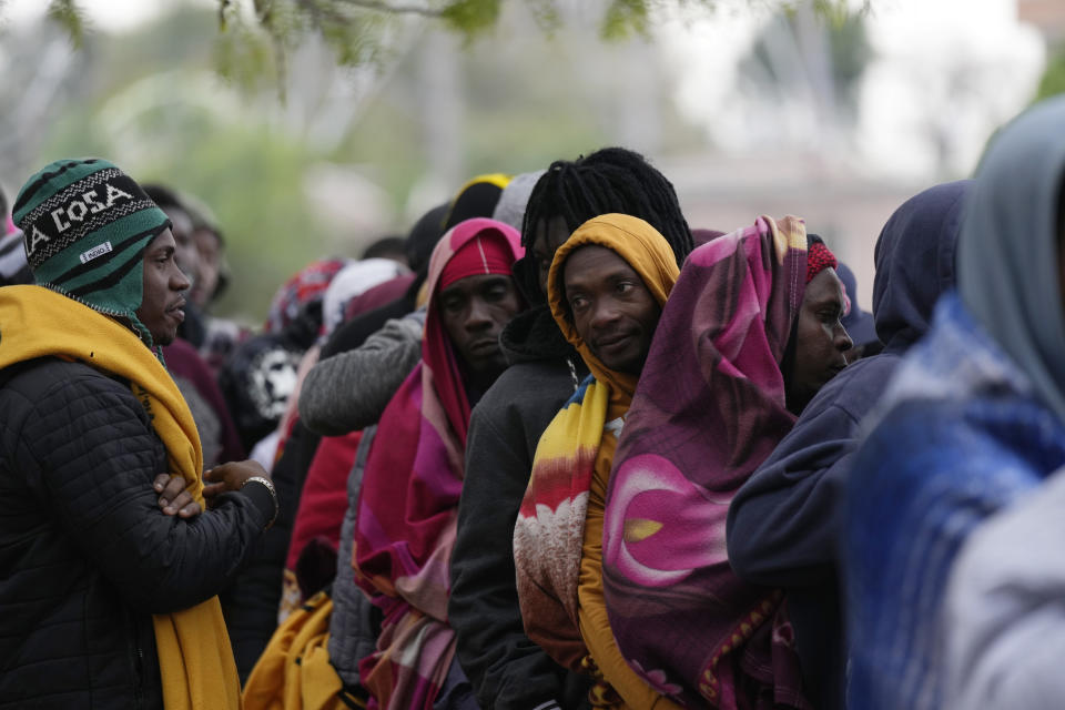 Haitians who hope to apply for asylum in the U.S. wait to register their names on a list made by a religious organization in Reynosa, Mexico, Wednesday, Dec. 21, 2022, on the other side of the border with McAllen, Texas. (AP Photo/Fernando Llano)