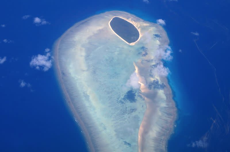 FILE PHOTO: Coral surrounds a small island on the Great Barrier Reef, located off the coast of Queensland, near the town of Rockhampton