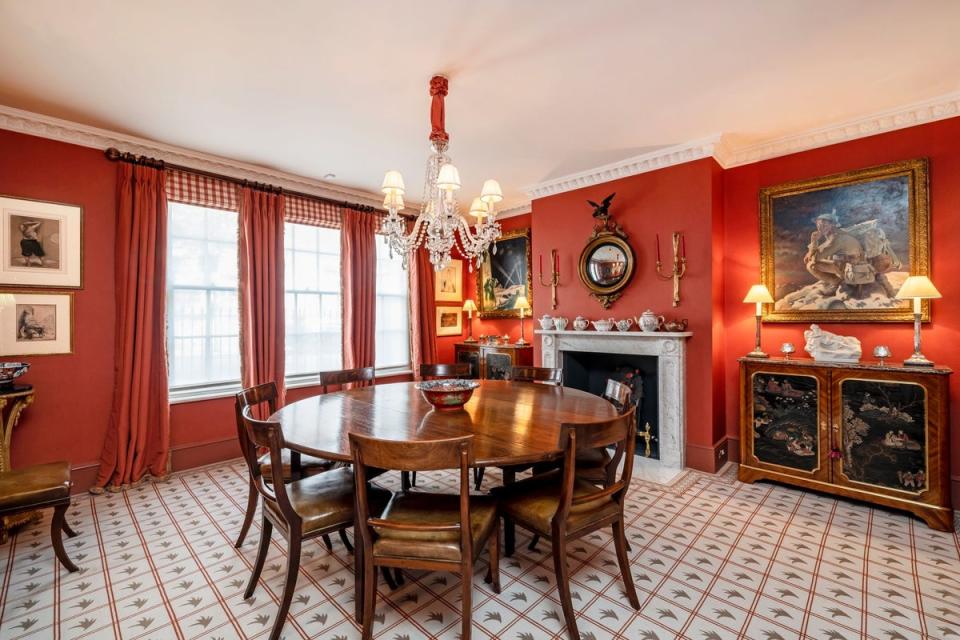 The dining room is still in the same shade of red also used on the walls of the Spencer family seat (Wetherell/Chestertons)