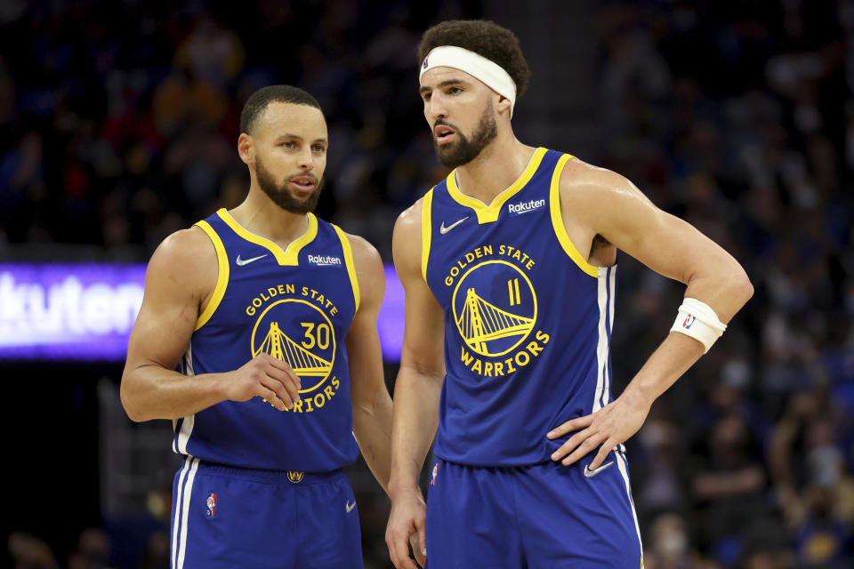 Golden State Warriors guard Stephen Curry (30) and guard Klay Thompson (11) talk during the first half of the team's NBA basketball game against the Indiana Pacers in San Francisco, Thursday, Jan. 20, 2022. (AP Photo/Jed Jacobsohn)