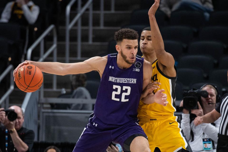 Northwestern forward Pete Nance, left, posts up against Iowa forward Keegan Murray in a Big Ten Tournament game May 6, 2022, in Indianapolis.