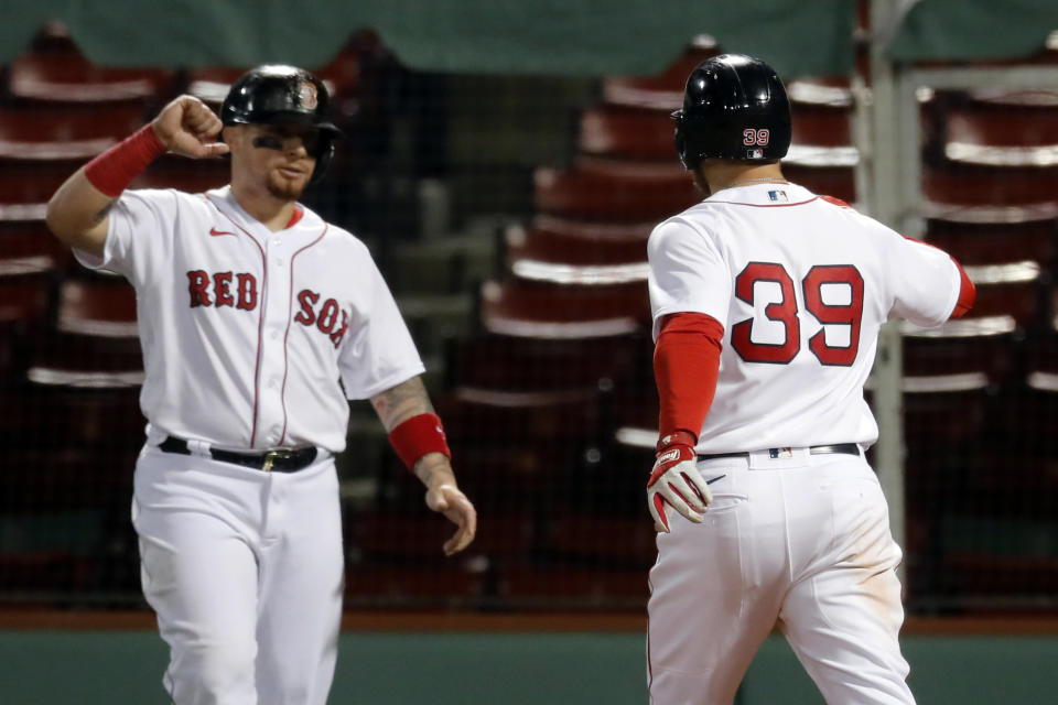 Boston Red Sox's Christian Arroyo (39) celebrates his three-run home run that also drove in Christian Vazquez, left, during the fourth inning of the team's baseball game against the New York Yankees, Friday, Sept. 18, 2020, in Boston. (AP Photo/Michael Dwyer)