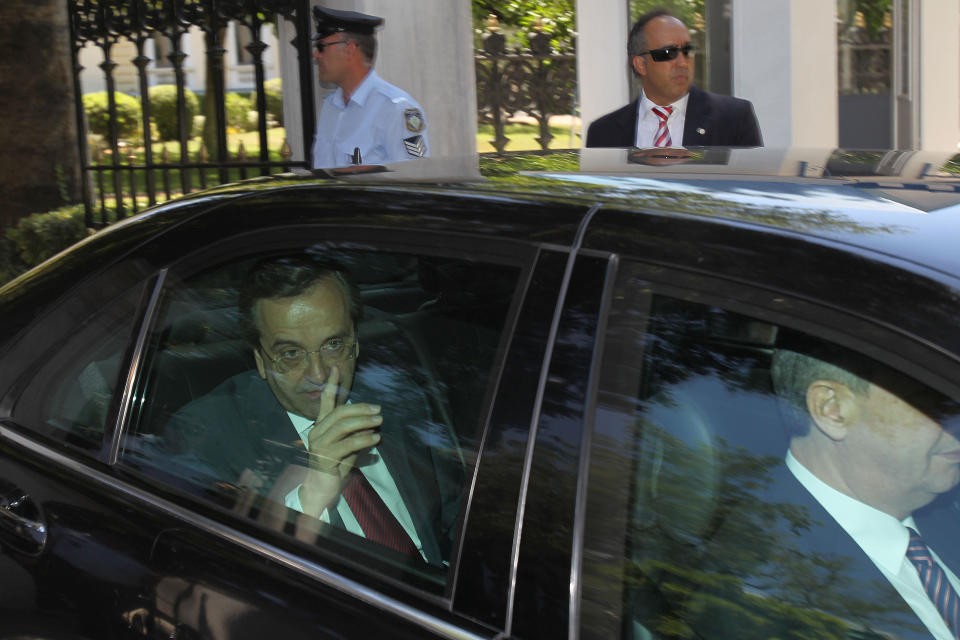 Greece's conservative election victor Antonis Samaras leaves the presidential palace after meeting Greek President Karolos Papoulias in Athens, Monday, June 18 2012. Europe looked on with wary relief Monday as Samaras received a mandate to launch coalition talks after coming first in national elections that follow weeks of uncertainty over the debt-crippled country's future in the continent's joint currency. (AP Photo/Petros Karadjias)