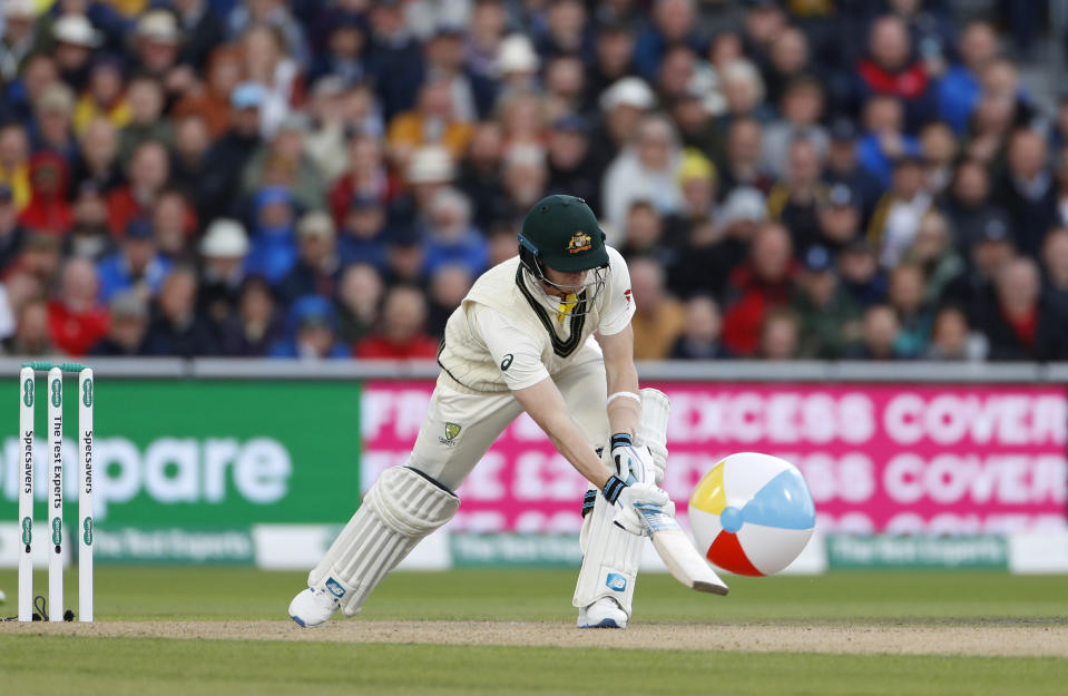 Australia's Steve Smith clears a rubber ball that entered the field during day one of the fourth Ashes Test cricket match between England and Australia at Old Trafford in Manchester, England, Wednesday, Sept. 4, 2019. (AP Photo/Rui Vieira)