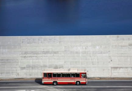 A bus is driven past a seawall in Yamada village, Iwate Prefecture, Japan, March 3, 2018. REUTERS/Kim Kyung-Hoon