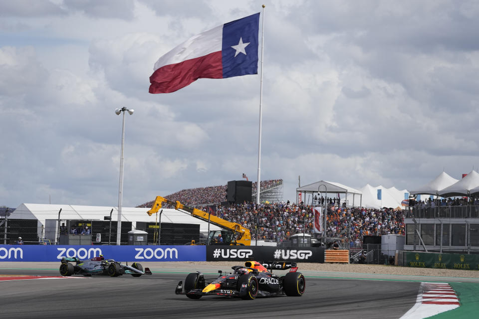 Red Bull driver Max Verstappen, right, of the Netherlands, leads Mercedes driver Lewis Hamilton, of Britain, out of a turn during the Formula One U.S. Grand Prix auto race at Circuit of the Americas, Sunday, Oct. 23, 2022, in Austin, Texas. (AP Photo/Charlie Neibergall)