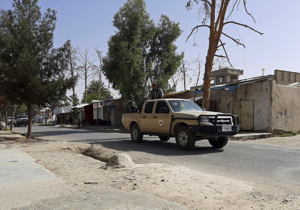 Afghan security personnel patrol a deserted street during fighting between Taliban and Afghan security forces, in Lashkar Gah, Helmand province, southern Afghanistan, Tuesday, Aug. 3, 2021. The Taliban pressed on with their advances in Afghanistan's southern Helmand province on Tuesday as Afghan forces launched airstrikes to defend the provincial capital. (AP Photo/Abdul Khaliq)