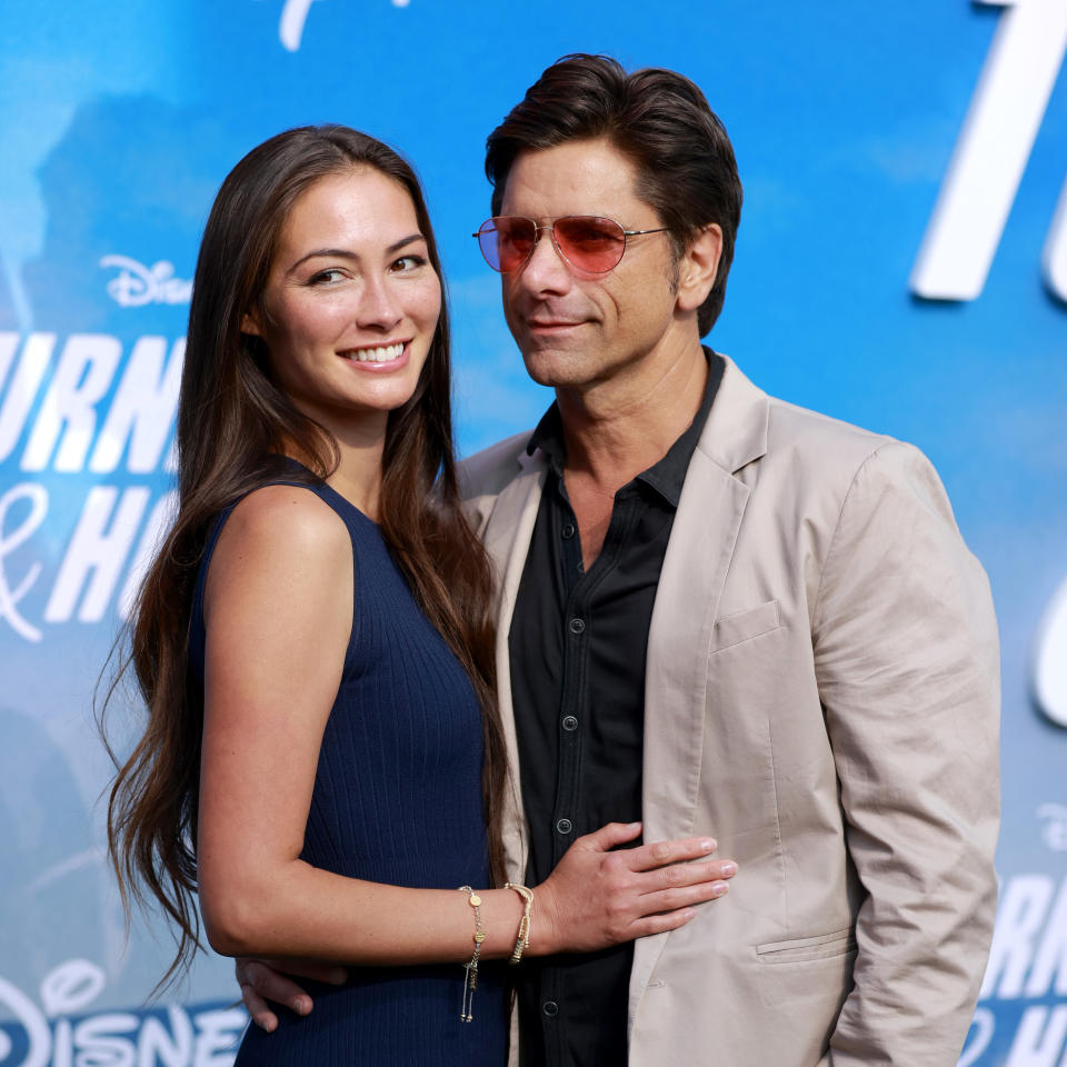 Caitlin McHugh and John Stamos attend the Disney+ "Turner & Hooch" Premiere at Westfield Century City Mall on July 15, 2021