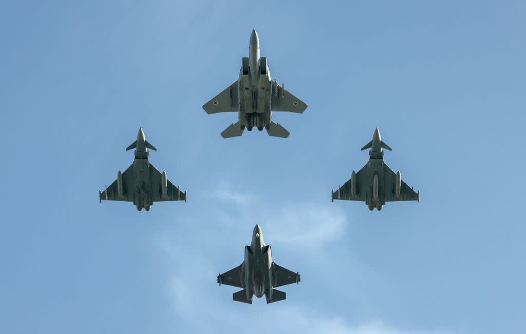 Israel and German (L and R) fighter jets fly over the Knesset, Israel’s parliament, during a flyby in a display of cooperation between the two countries and their armies, in Jerusalem  (Getty Images)