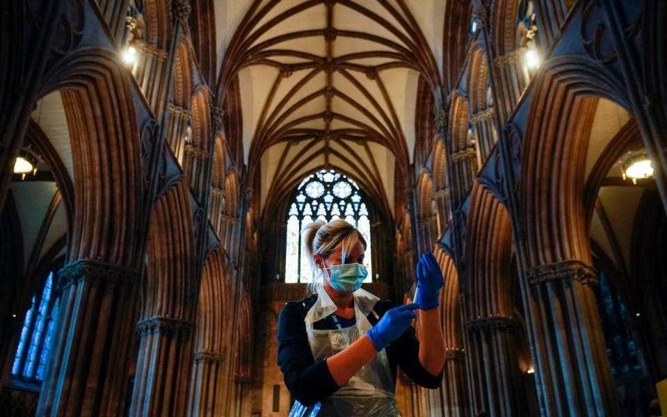 A nurse draws up a vaccine as members of the public receive their Covid-19 vaccinations at Lichfield Cathedral, Staffordshire - Getty