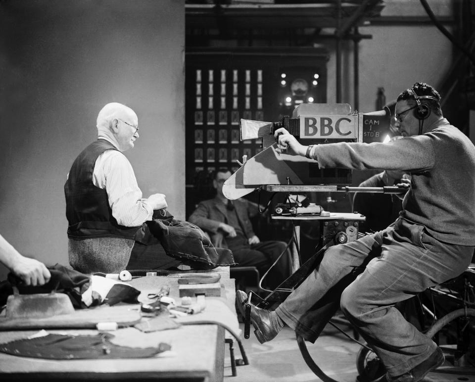 Tailor W.T. Rogers at work in front of the camera during his 'Made by Hand' series, being televised by the B.B.C.