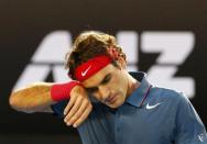 Roger Federer of Switzerland wipes his head during his men's singles semi-final match against Rafael Nadal of Spain at the Australian Open 2014 tennis tournament in Melbourne January 24, 2014. REUTERS/Petar Kujundzic