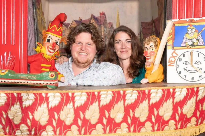 Auctioneer John Rolfe and Office Manager Laura Ashcroft with the Victorian Punch and Judy set.