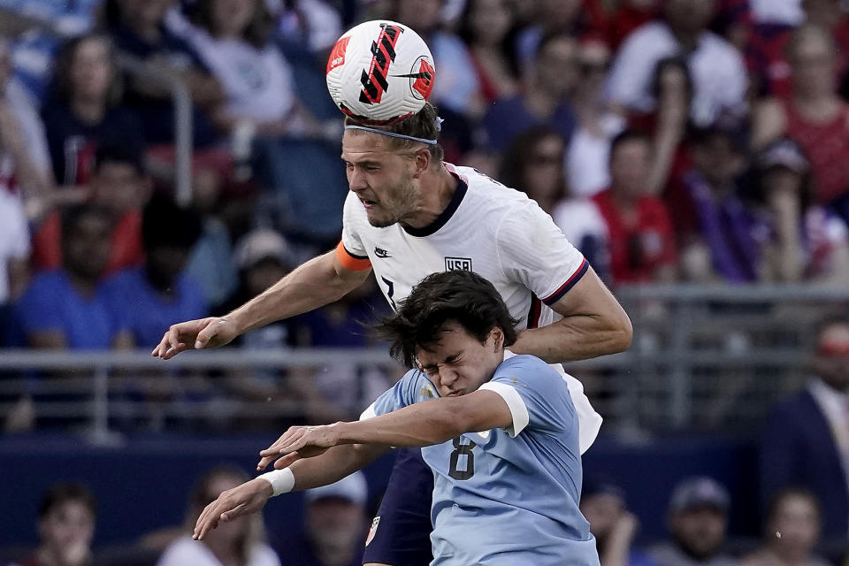Uruguay forward Facundo Pellistri (8) and USA defender Walker Zimmerman, back, battle for the ball during the second half of an international friendly soccer match Sunday, June 5, 2022, in Kansas City, Kan. The match ended in a 0-0 tie. (AP Photo/Charlie Riedel)