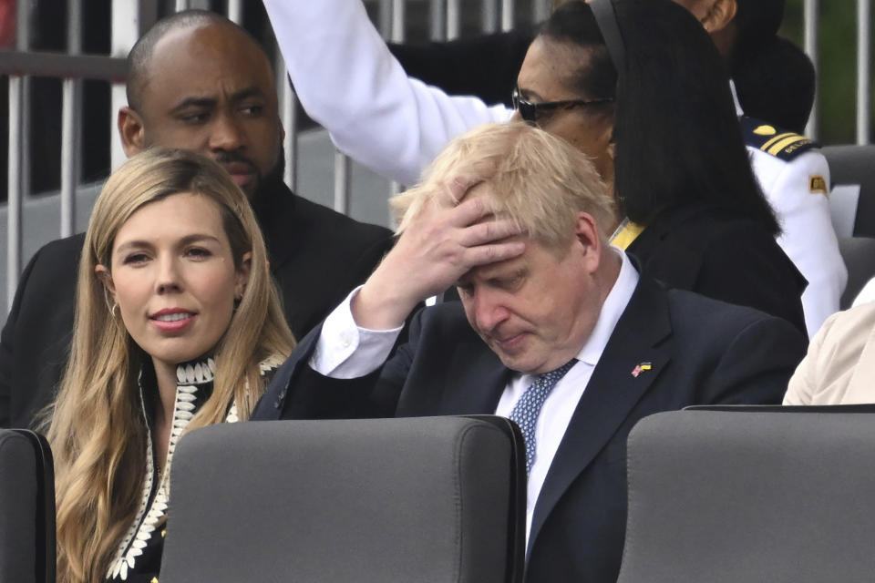 FILE - Britain's Prime Minister Boris Johnson and his wife Carrie, are seated during the Platinum Jubilee Pageant, in London, Sunday June 5, 2022. When British Prime Minister Boris Johnson survived a no-confidence vote this week, at least one other world leader shared his relief. Ukrainian President Volodymyr Zelenskyy said it was “great news” that “we have not lost a very important ally.” It was a welcome endorsement for a British leader who divides his country, and his party, but has won wide praise as an ally of Ukraine. (Chris Jackson/Pool Photo via AP, File)