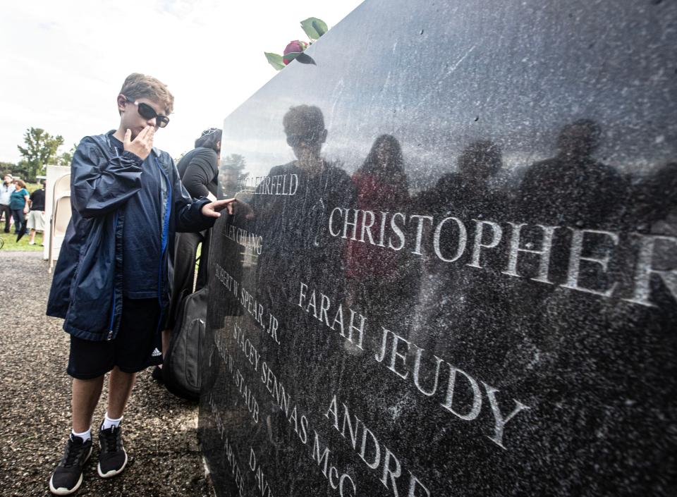Eli Burrows, 10, of Woodcliff Lake, N.J. touches the name of his uncle, Eric Lehrfeld, a native of New City, who died in the Sept. 11 attacks on the World Trade Center. Eli was attending a ceremony at the Rockland County 9/11 Memorial in Haverstraw marking the 22nd anniversary of the Sept. 11 attacks.