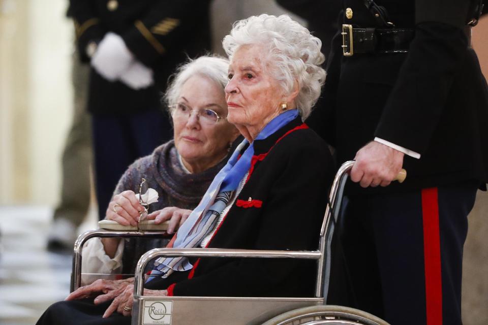 Annie Glenn, center, looks at her husband John Glenn's casket alongside her daughter Carolyn Ann Glenn as he lies in honor, Friday, Dec. 16, 2016, in Columbus, Ohio. Glenn's home state and the nation began saying goodbye to the famed astronaut who died last week at the age of 95. (AP Photo/John Minchillo)