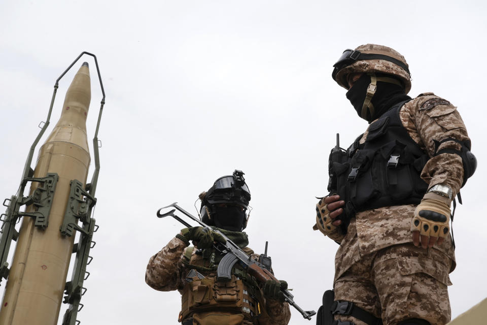 Iran's Revolutionary Guard members stand in front of Shahab-3 missile which is displayed during the annual pro-Palestinians Al-Quds, or Jerusalem, Day rally in Tehran, Iran, Friday, April 29, 2022. Iran does not recognize Israel and supports Hamas and Hezbollah, militant groups that oppose it. (AP Photo/Vahid Salemi)