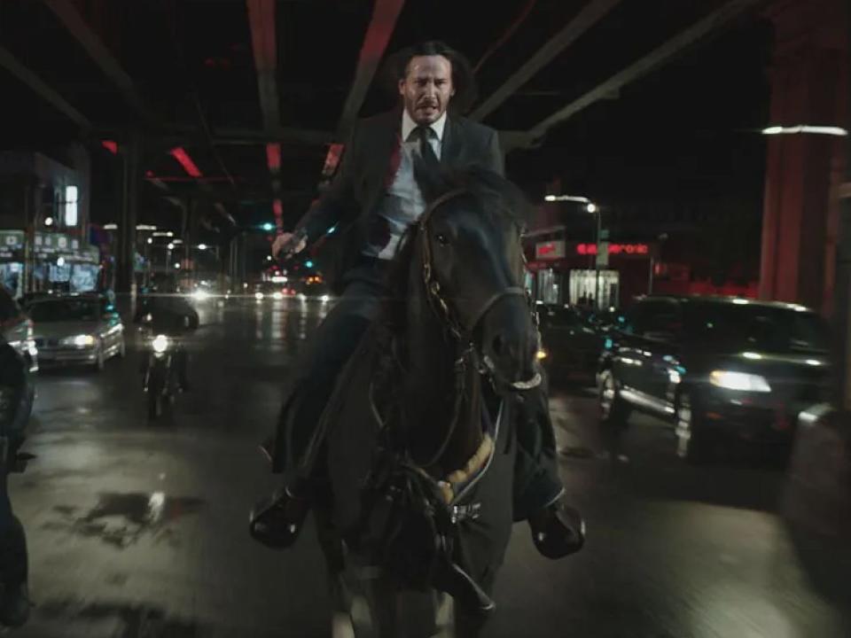 Keanu Reeves as John Wick on a horse in New York.