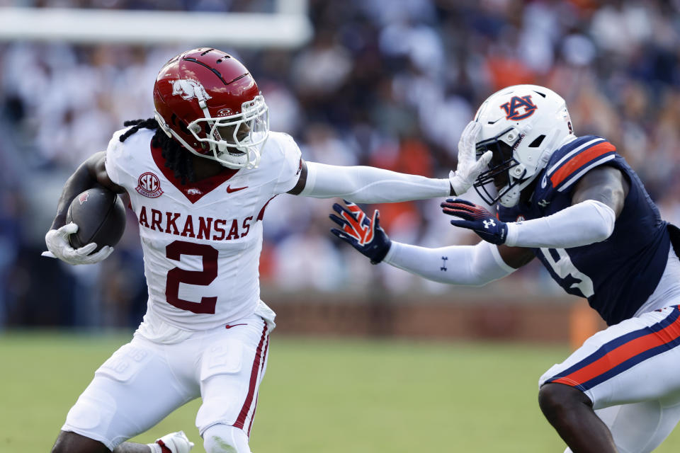 Arkansas wide receiver Andrew Armstrong (2) stiff arms Auburn linebacker Eugene Asante (9) as he carries the ball during the first half of an NCAA college football game, Saturday, Sept. 21, 2024, in Auburn, Ala.(AP Photo/Butch Dill)