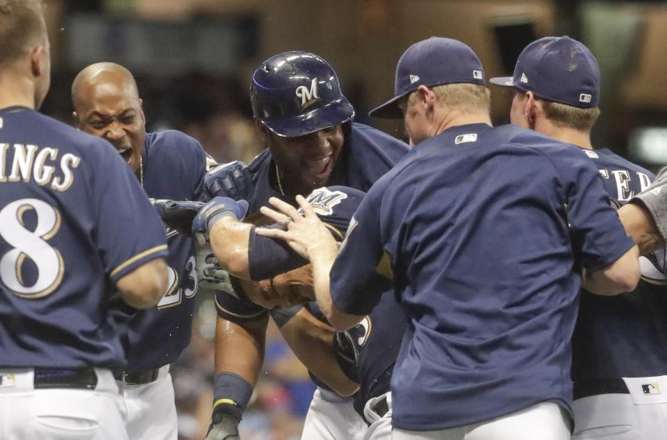 Milwaukee Brewers’ Tyler Saladino is congratulated after hitting a walk-off sacrifice fly during the 10th inning of a baseball game against the Washington Nationals Tuesday, July 24, 2018, in Milwaukee. The Brewers won 5-4. (AP Photo/Morry Gash)