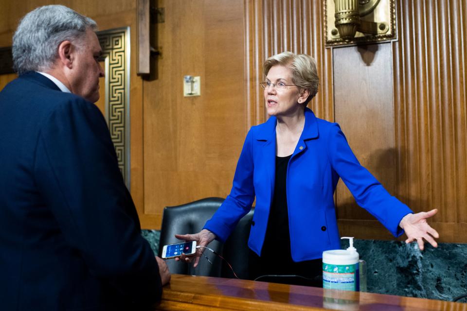 Charles P. Rettig, commissioner of the Internal Revenue Service, speaks with Senator Elizabeth Warren, D-Mass., before testifying  during a Senate Finance Committee hearing on the IRS budget request on Capitol Hill in Washington,DC on June 8, 2021. (Photo by Tom Williams / POOL / AFP) (Photo by TOM WILLIAMS/POOL/AFP via Getty Images)