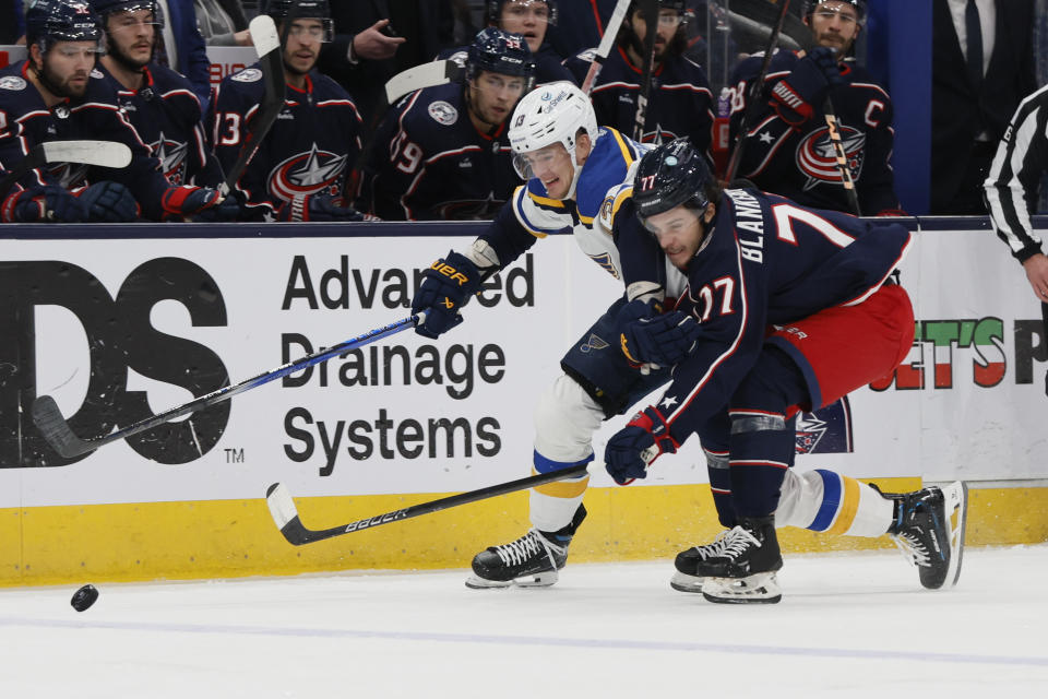 St. Louis Blues' Alexey Toropchenko, left, and Columbus Blue Jackets' Nick Blankenburg chase the puck during the first period of an NHL hockey game Friday, Dec. 8, 2023, in Columbus, Ohio. (AP Photo/Jay LaPrete)