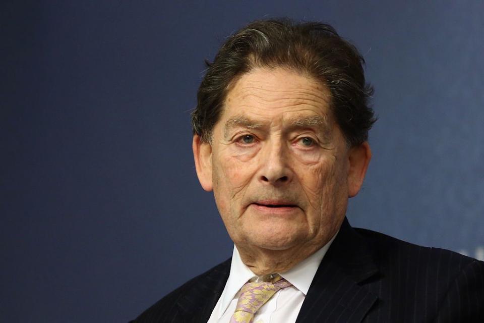 former cabinet minister nigel lawson, farther of nigella lawson, speaks to guests at chatham house, wearing a suit