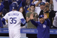 Los Angeles Dodgers' Cody Bellinger, left, celebrates with manager Dave Roberts after hitting a solo home run during the eighth inning of a baseball game against the San Diego Padres Wednesday, Sept. 29, 2021, in Los Angeles. (AP Photo/Mark J. Terrill)