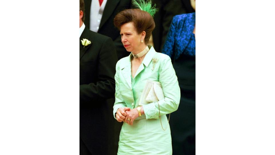 Princess Anne in a green dress with a feather hair accessory