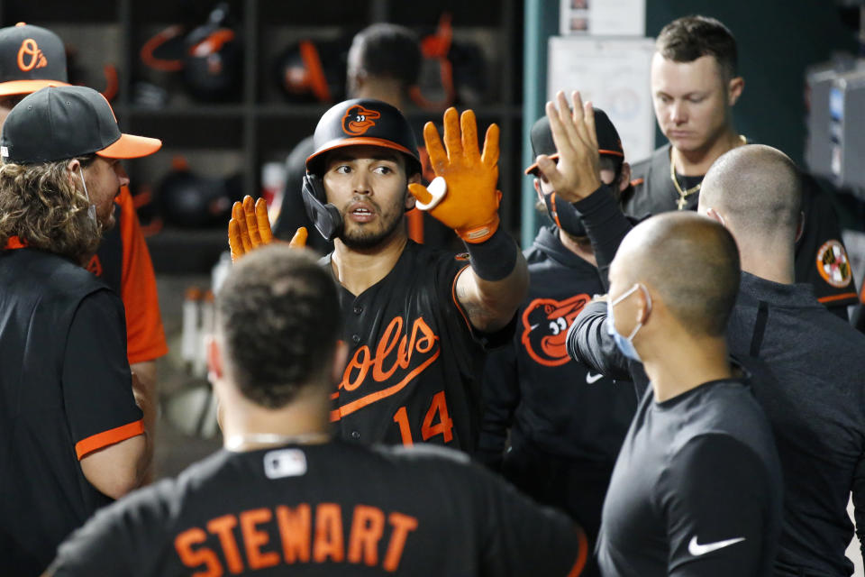 Baltimore Orioles' Rio Ruiz (14) is congratulated by teammates in the dugout after hitting a home run during the fourth inning of the team's baseball game against the Texas Rangers in Arlington, Texas, Friday, April 16, 2021. (AP Photo/Roger Steinman)