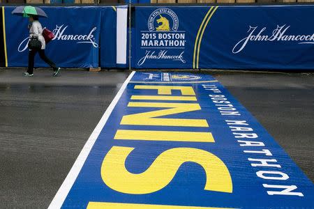 A woman walks near the Boston Marathon finish line in Boston, Massachusetts, April 17, 2015. REUTERS/Dominick Reuter