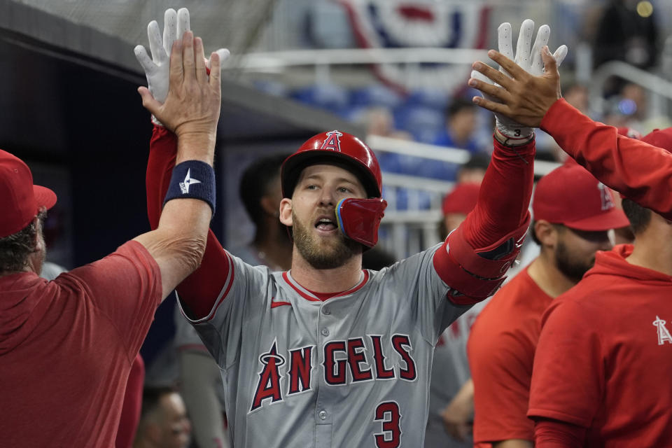 Teammates congratulate Los Angeles Angels' Taylor Ward (3) after hitting a home run during the eighth inning of a baseball game against the Miami Marlins, Wednesday, April 3, 2024, in Miami. The Angels defeated the Marlins 10-2. (AP Photo/Marta Lavandier)