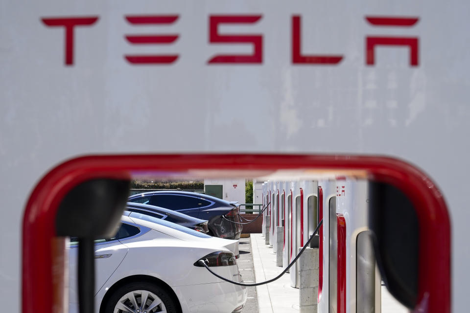 FILE - Tesla vehicles charge at a station in Emeryville, Calif., Aug. 10, 2022. Electric vehicles made by General Motors will be able to use much of Tesla's vast charging network starting early next year. GM joins Ford in shifting its vehicles to about 12,000 of Tesla's chargers, and both Detroit automakers are pushing to make Tesla's connector the industry standard. (AP Photo/Godofredo A. Vásquez, File)