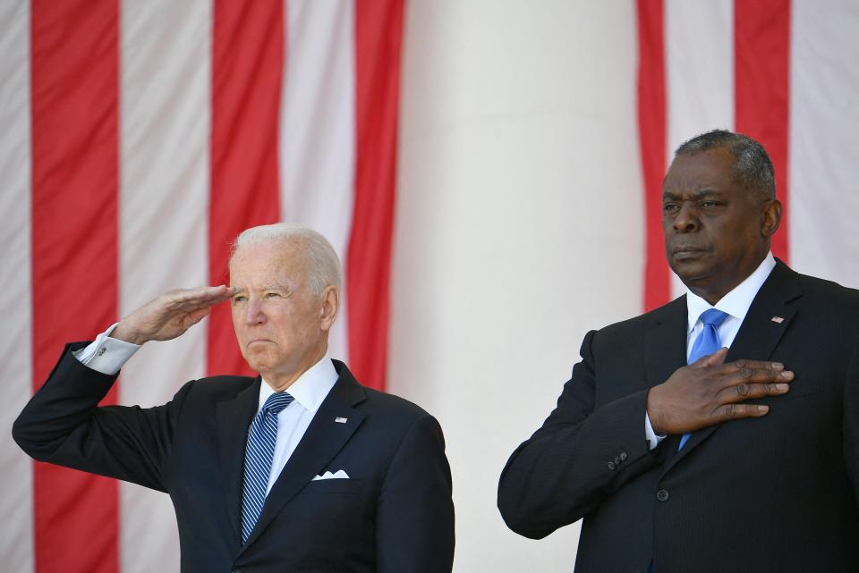 President Joe Biden salutes next to Defense Secretary Lloyd Austin at the 153rd National Memorial Day Observance at  Arlington National Cemetery on May 31, 2021.