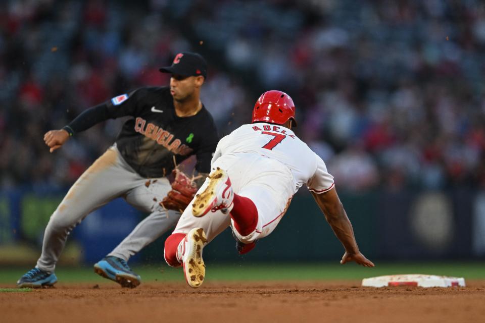 Angels outfielder Jo Adell (7) attempts to steal second base as Guardians shortstop Brayan Rocchio (4) awaits the throw during the fourth inning, May 25, 2024, in Anaheim.