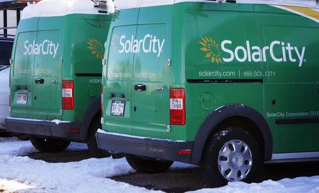 Trucks are seen parked outside the SolarCity building in Denver February 17, 2015. REUTERS/Rick Wilking