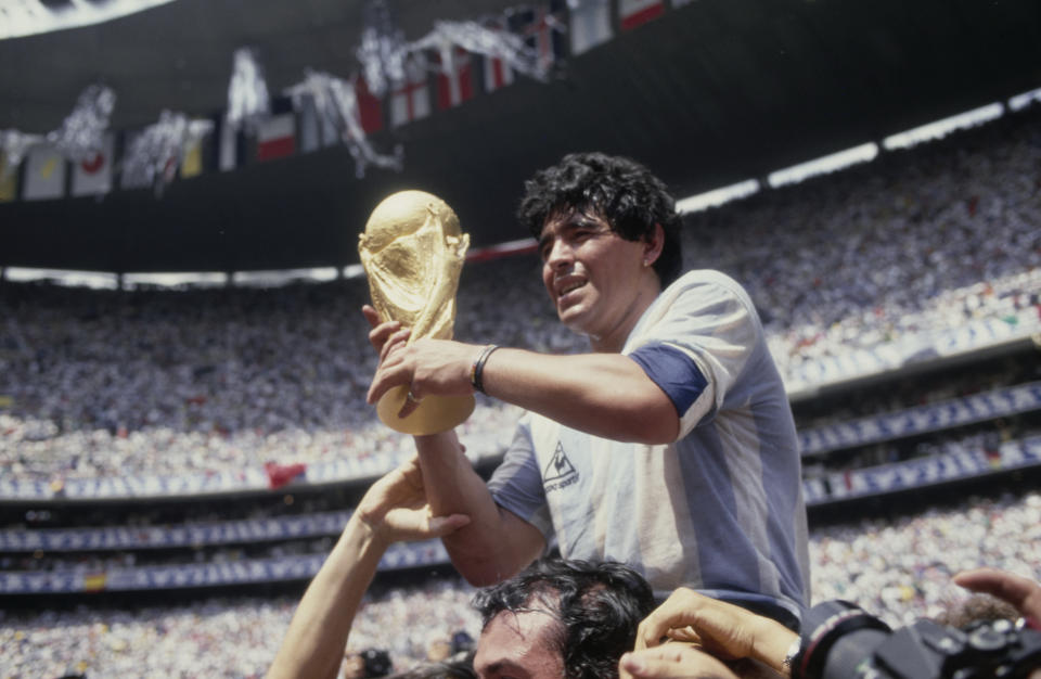 Argentine professional football player Diego Armando Maradona (1960 - 2020) holds the World Cup trophy after Argentina defeated West Germany 3-2 during the 1986 FIFA World Cup Final match at the Azteca Stadium in  Mexico City, Mexico, 29th June 1986. (Photo by Bongarts/Getty Images)